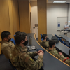 Professor talks with US Air Force Academy personnel in classroom