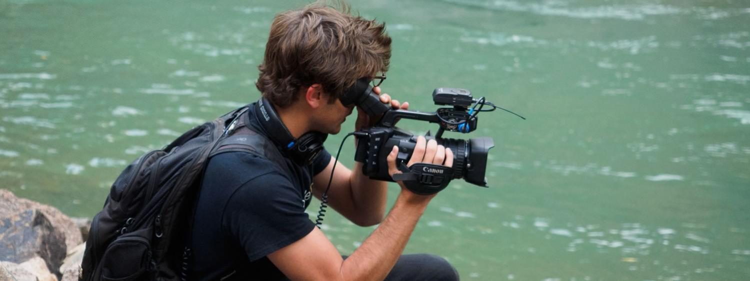 student films in front of water