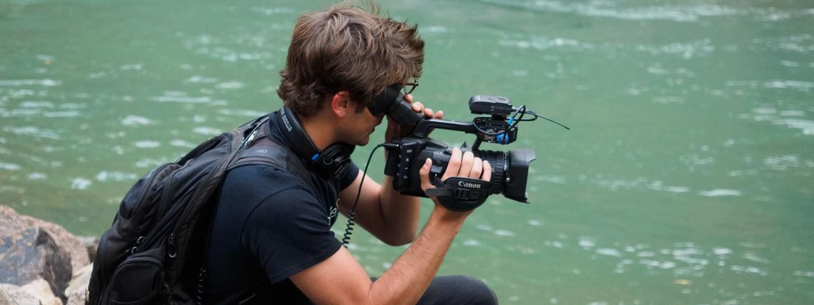 student films in front of water