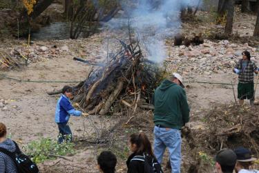 Volunteers stoke and tend the bonfire near Jeremy Barnes' house between Boulder and Lyons, Colo., Oct. 12, 2013. Barnes' house was nearly destroyed in the September flood that devastated the town. Photo by Emilie Bierschenk.