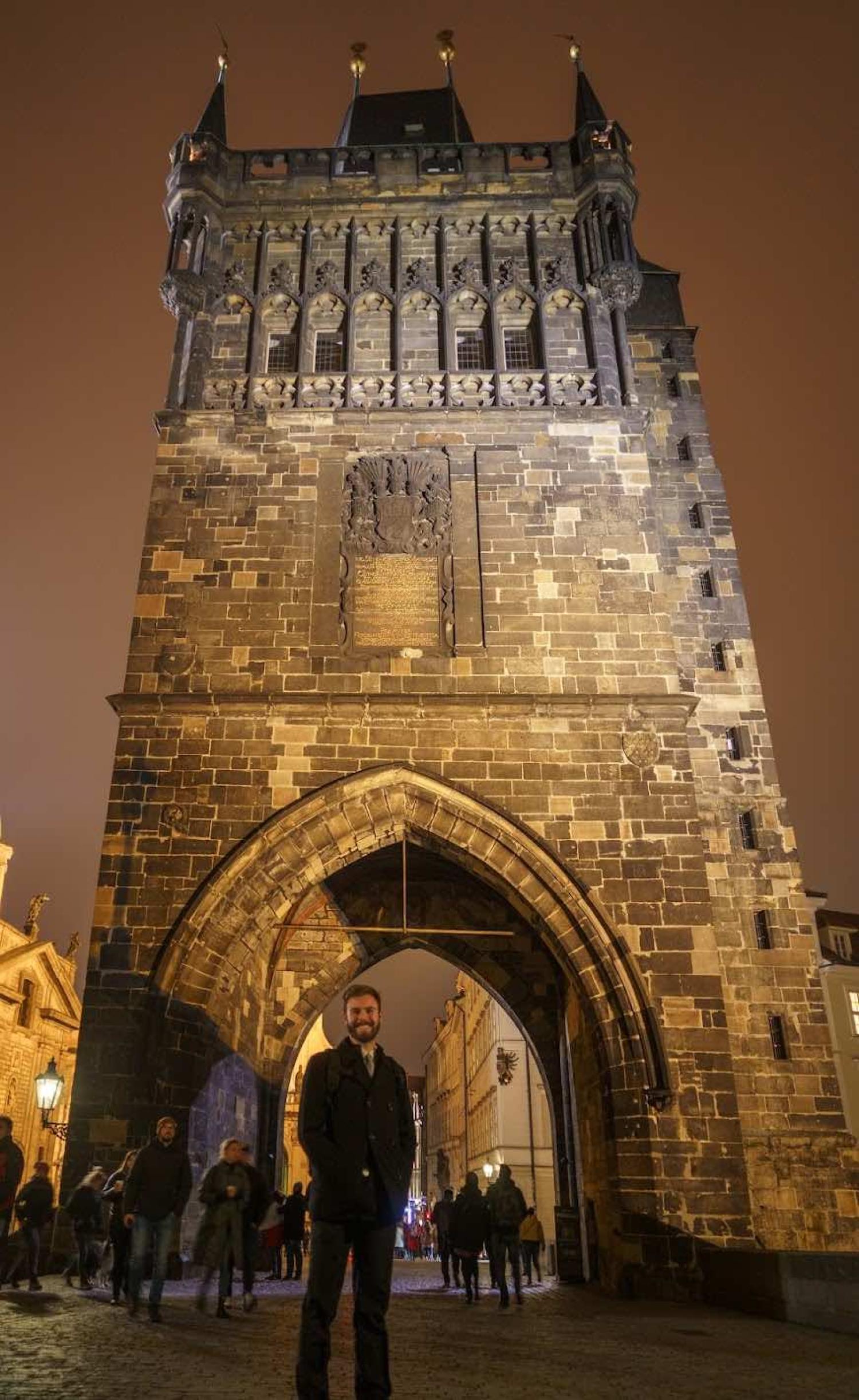 This is an image of Mack Rodgers standing underneath the Old Town Bridge tower in Prague on his way back from the policy session of the PULS Conference