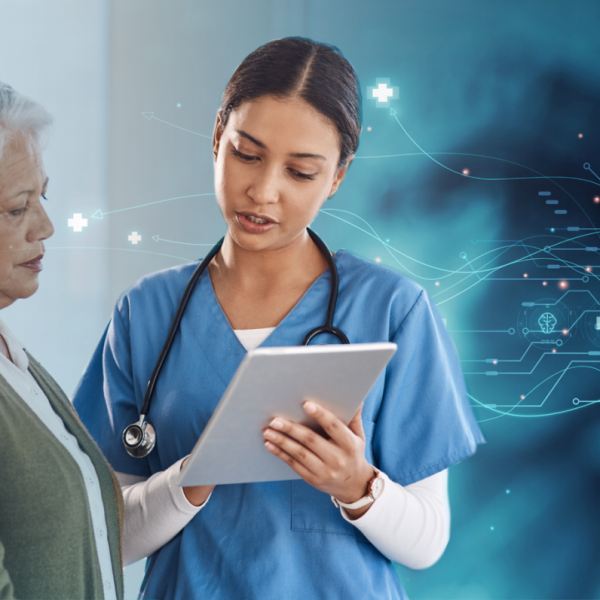A healthcare professional and a layperson review information on a handheld device.