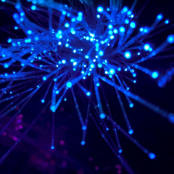 Fiber optic cables glowing in a dark space