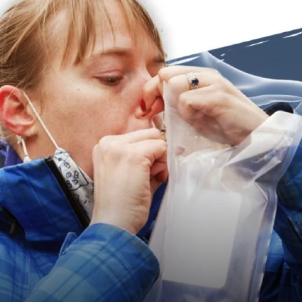 Woman using breathalyzer