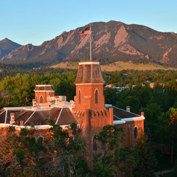 CU Boulder's Old Main building in front of the flatirons