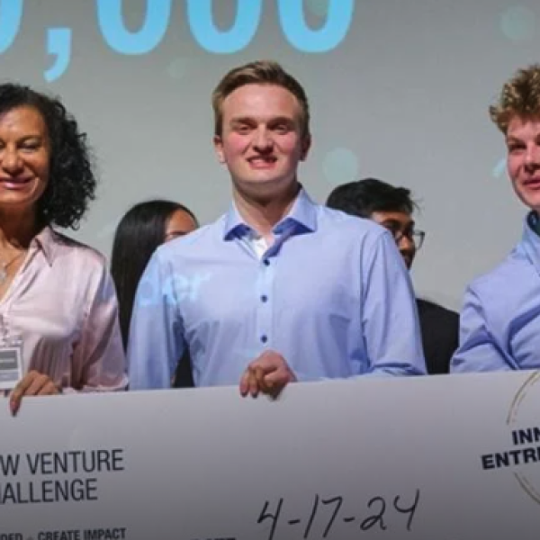 Young white man poses for a picture with a giant prize check