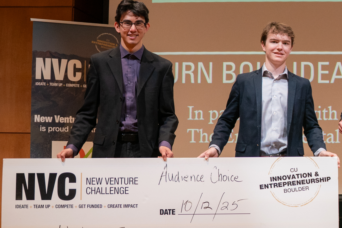 CU Boulder students Kai Groudan and Duncan Laird holding their Audience Choice check from the 2025 Colorado Sustainability Challenge