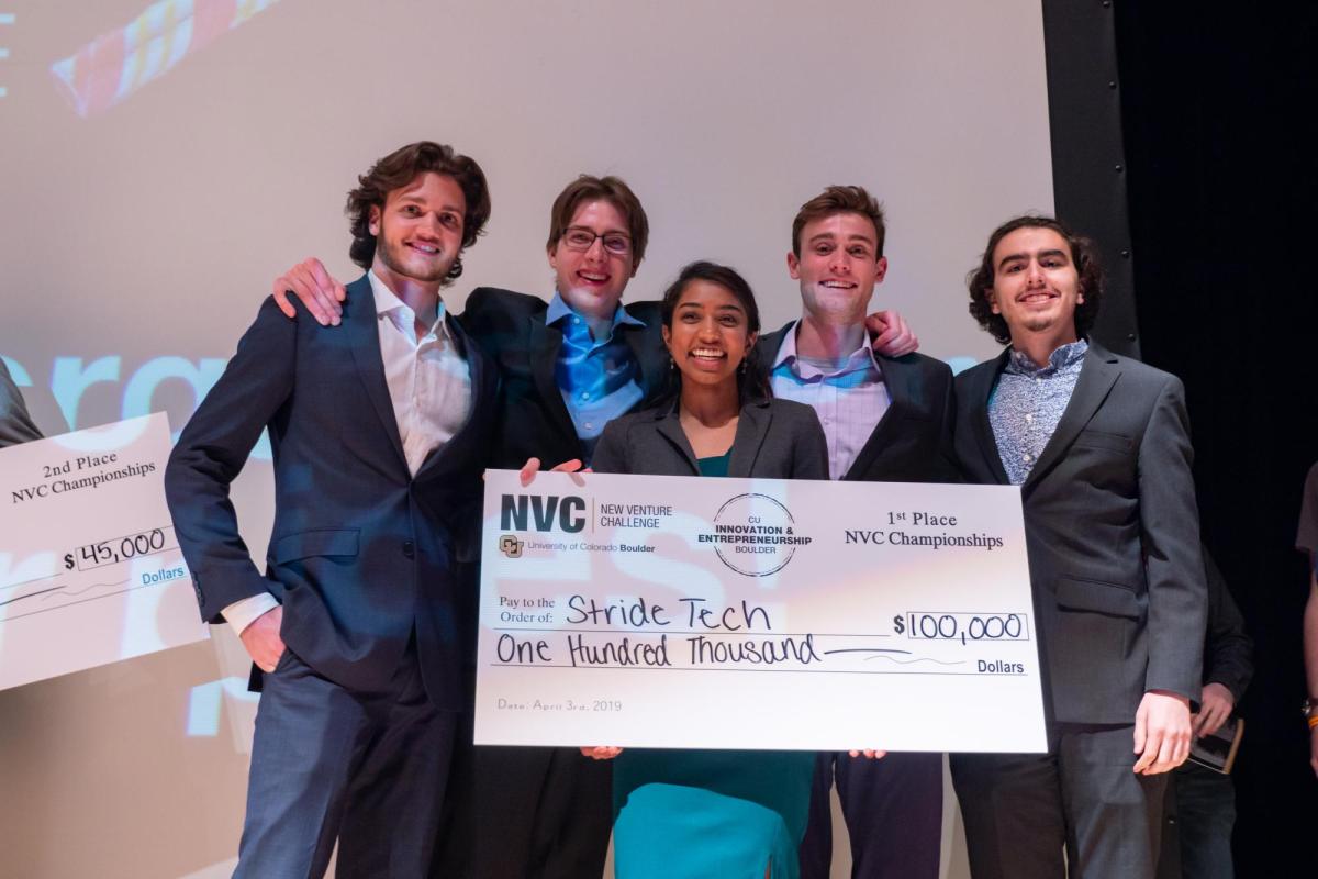 Winning team holds up a giant check