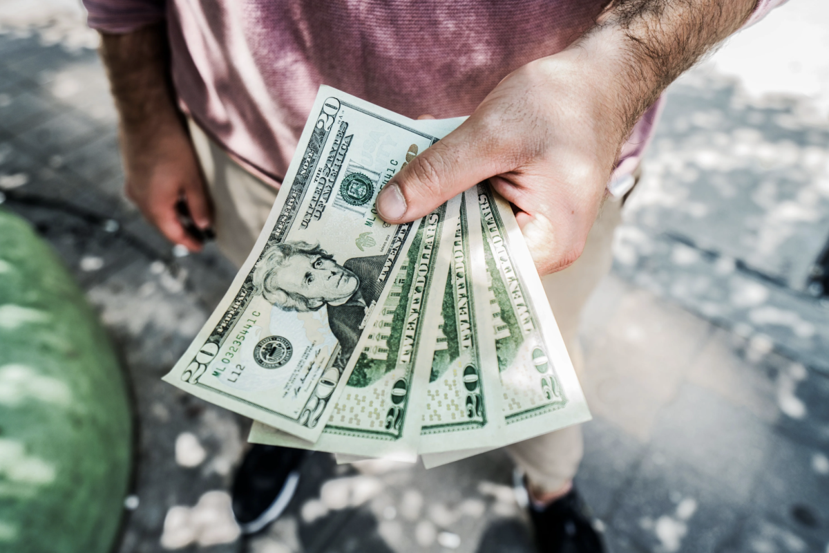 hands holding cash