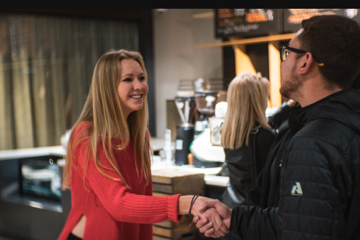 Young woman holds out her hand for a handshake