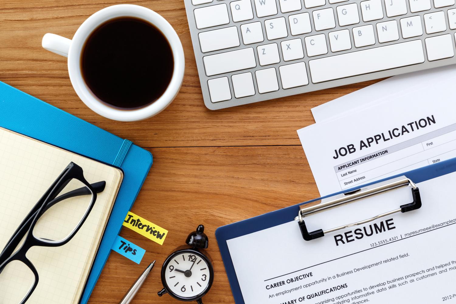 Overhead view of job search materials on a desk