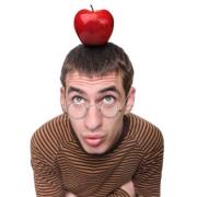 man with glasses with apple on his head
