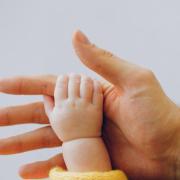 baby hand holding parent hand