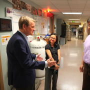 Senator Bennet visits with faculty in a research building