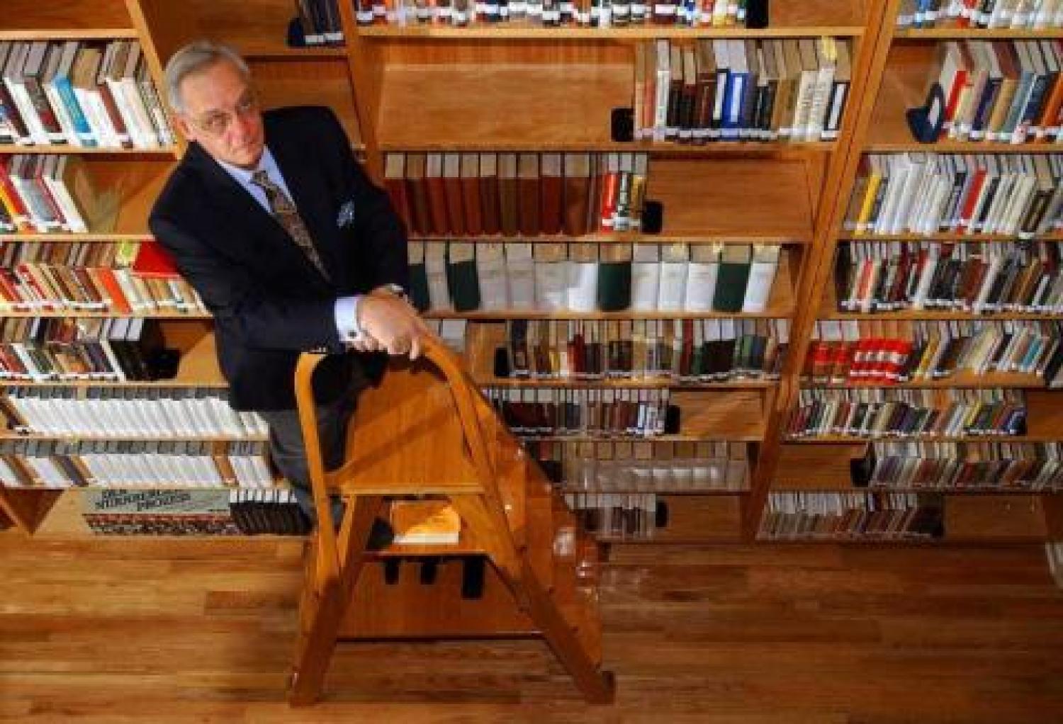 Harry Mazal on a ladder in his library