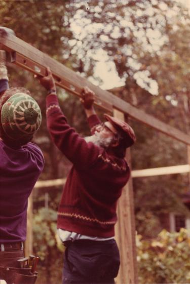 Rabbi Arthur Waskow helping to build a sukka