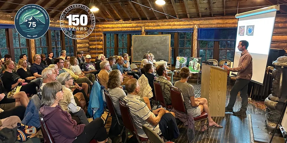 A rapt audience listens to a science talk inside a historic wooden structure. Logos are superimposed on the image for the 75th anniversary of INSTAAR and 150th anniversary of the University of Colorado Boulder