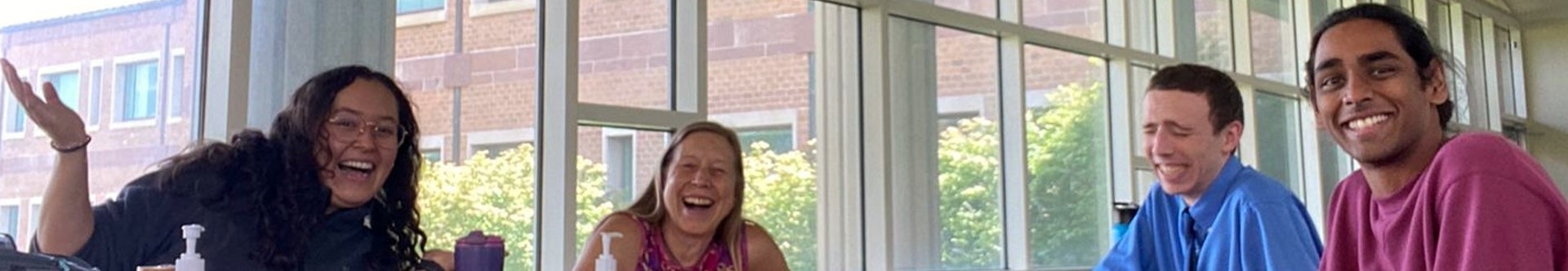 Four participants of the Spanish Language Lunch Table share a laugh