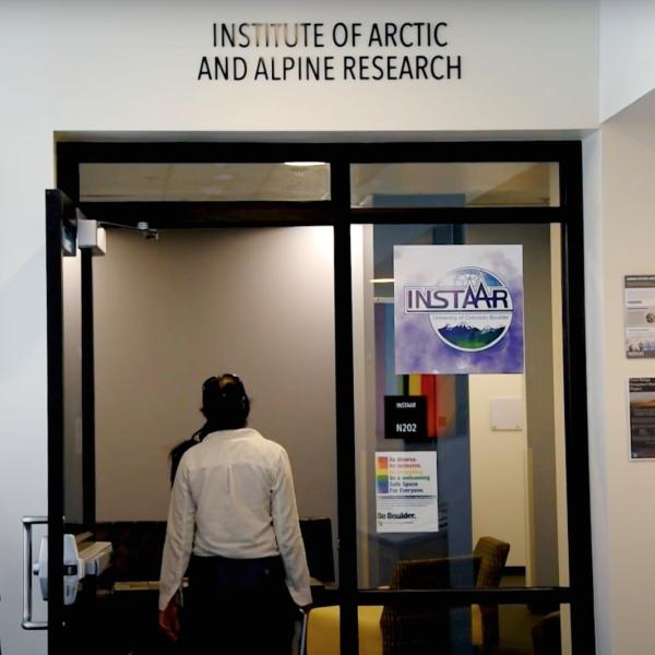 Person walks through the front door of the INSTAAR office
