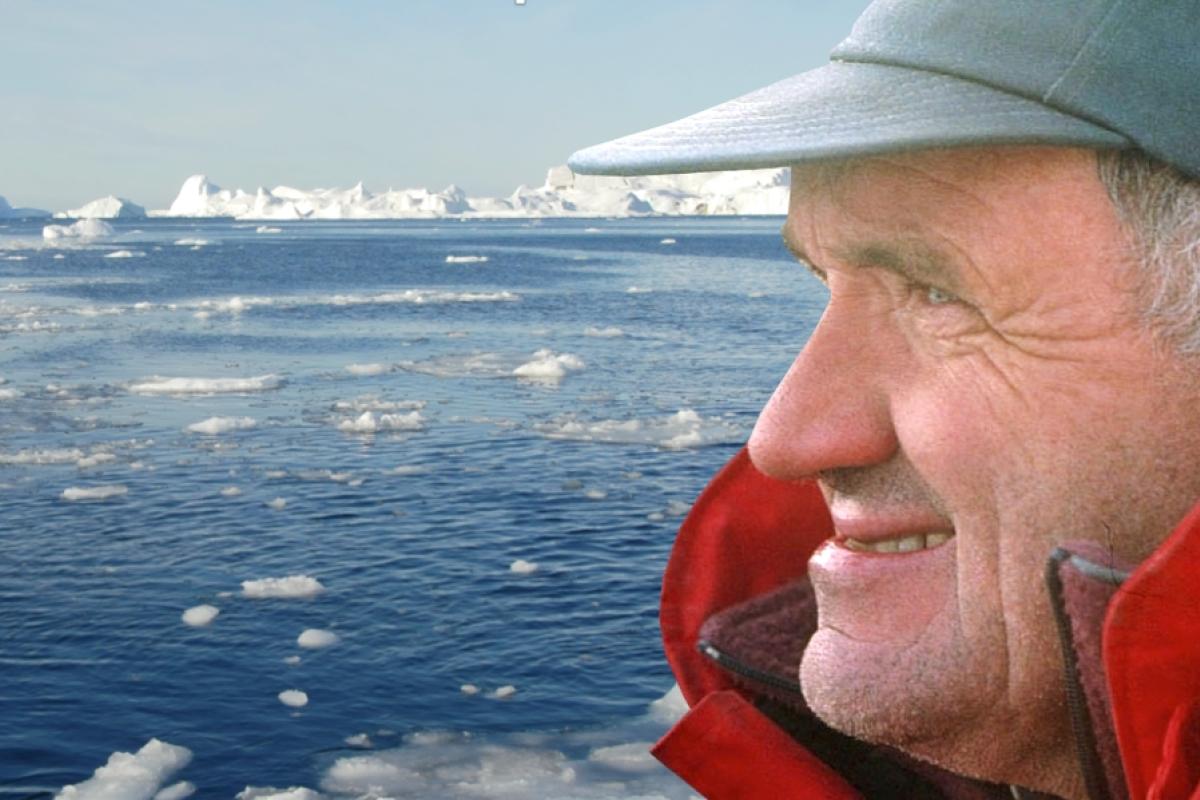 Profile view of John Andrews' head looking out over a sea-ice covered arctic sea