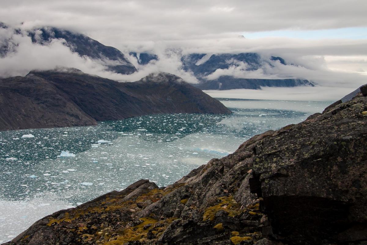 Dramatic view from one side of a steep rocky fjord across icy waters to the other side. Mellem Landet, near Narsarsuaq, Greenland. Credit: mahlersilvan
