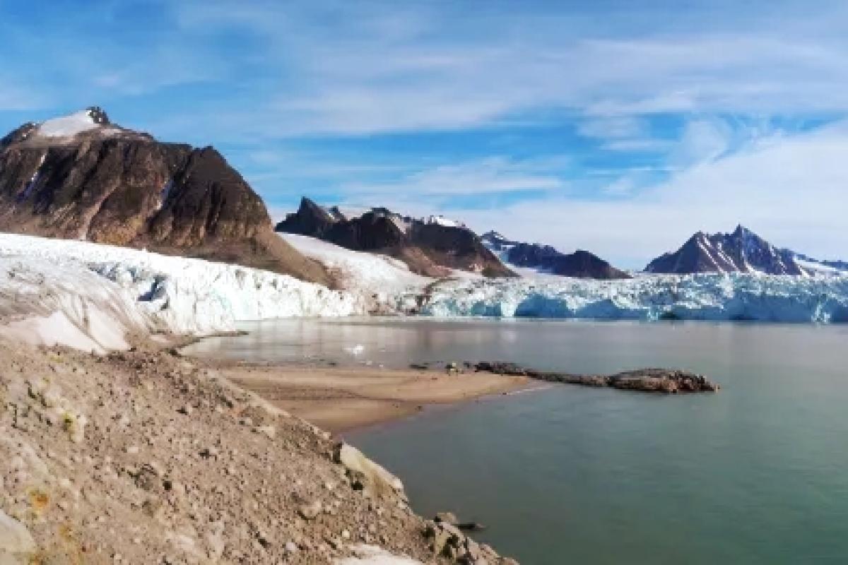 Three glaciers calve into the sea or impinge on land with jagged mountain peaks behind, Albert I Land, Spitsbergen, Svalbard (photo: M Furze)