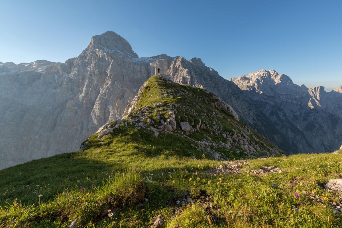 Mountain meadow with steep cliffs behind