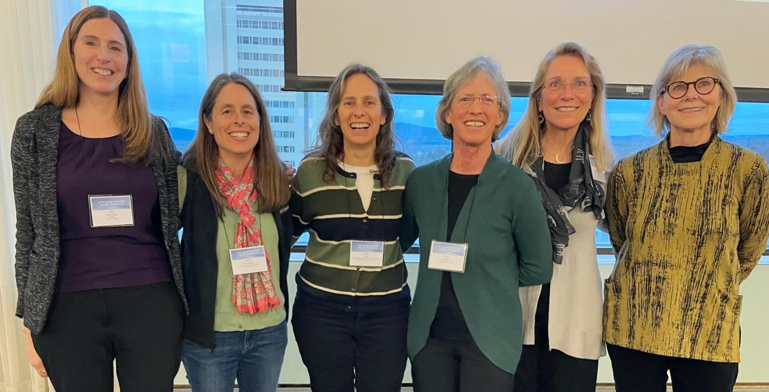Six female scientists join arms for a group photo at the 2024 Arctic Workshop in Amherst.  All are former students of the Workshop's founder John Andrews.  From left: Isla Castañeda, Sarah Principato, Kathy Licht, Anne Jennings, Julie Brigham-Grette, and Áslaug Geirsdóttir
