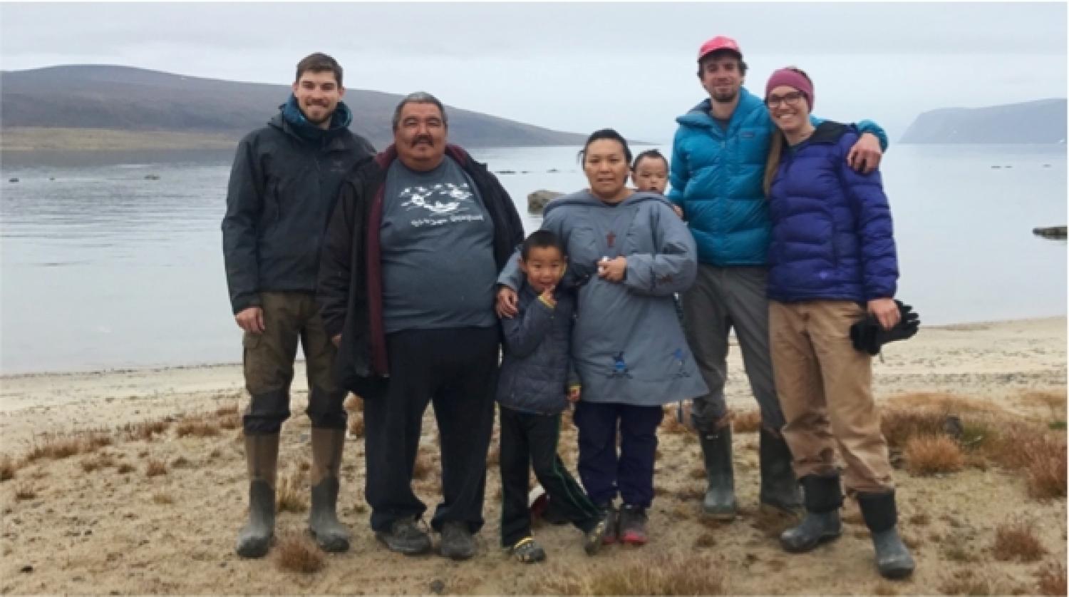 Greg de Wet (INSTAAR postdoc), Joshua Akavak (guide), Ina Akavak (Joshua's wife) with their children, Zach Montes (photographer, Orijin Media), and Sarah Crump (INSTAAR PhD student) by the Clyde River, Baffin Island.
