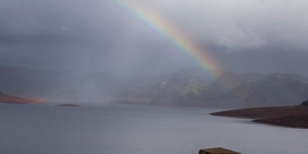 Rainbow visible over Lake Oroville from the top of Oroville Dam in Butte County California.