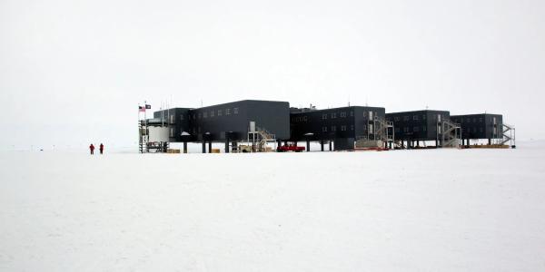 The American buildings of the Amundsen-Scott South Pole Station are stark black boxes on a white snowy ground. Photo by Vicki Beaver/Alamy.
