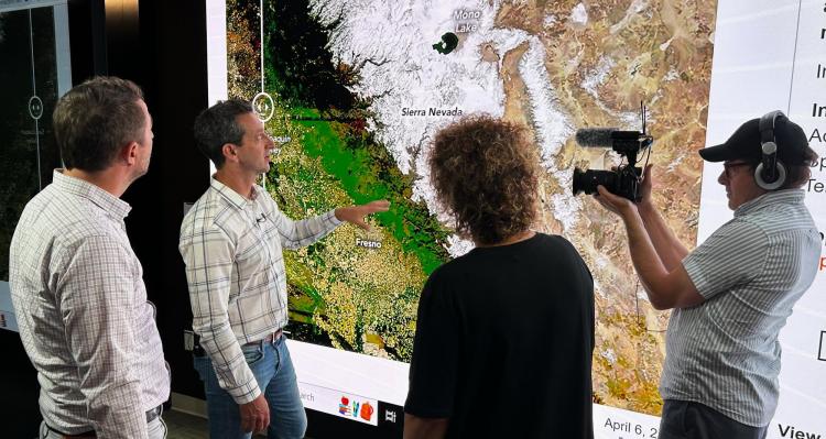 Noah Molotch shows an analysis of snow-water equivalent for California during a television interview at NASA Jet Propulsion Laboratory. Photo copyright by and courtesy of Pier Gagné, Radio-Canada.