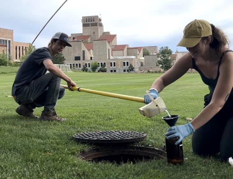 A research partner and Alli Cook sample a CU Boulder storm sewer in fall 2023.