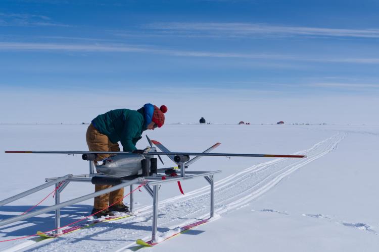 A drone team member prepares for launch.