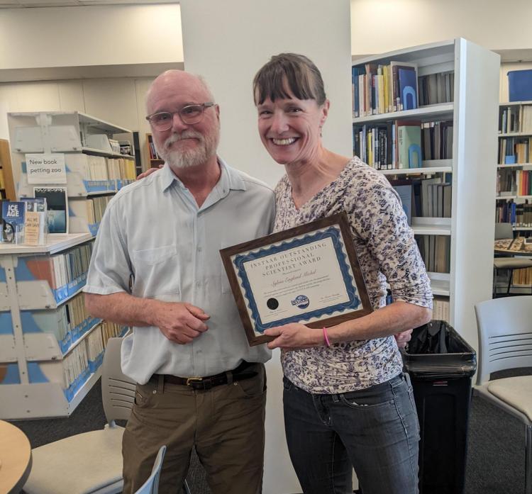 Bruce Vaughn presents Sylvia Michel with the Outstanding PRA Award.