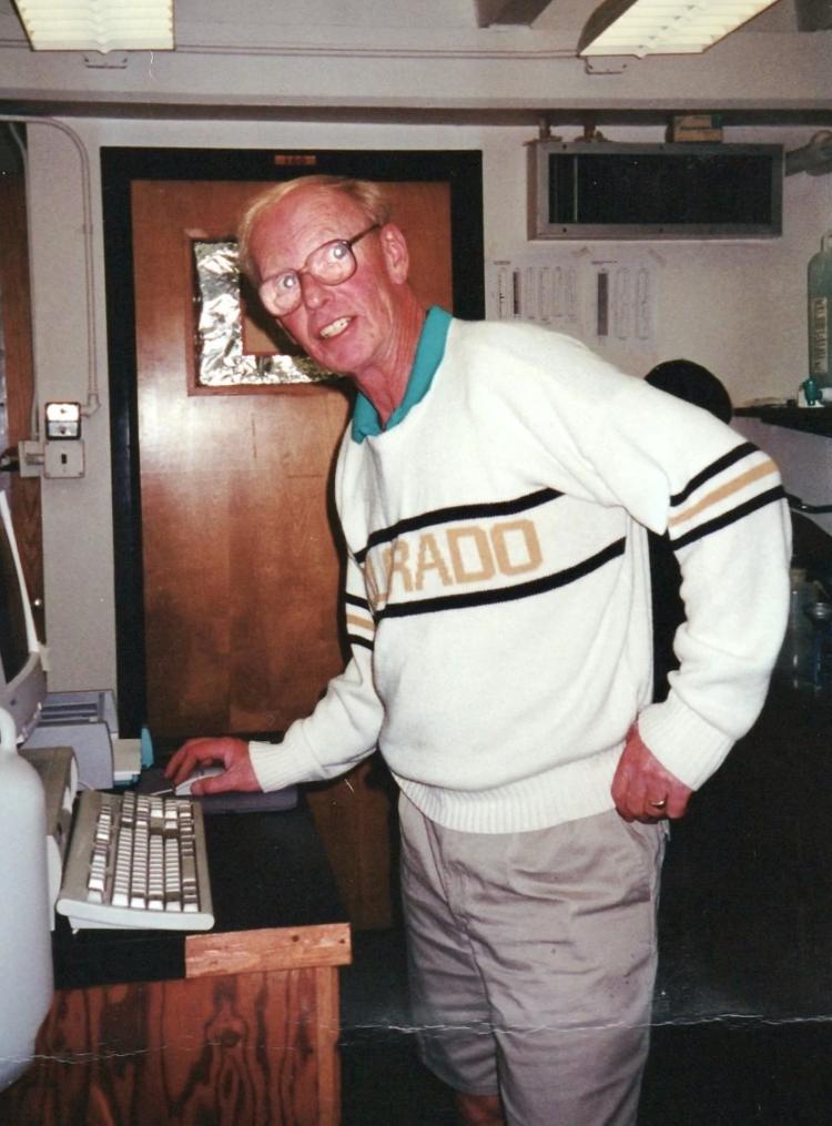 Rolf Kihl, with thick glasses, works in the INSTAAR Sed Lab while wearing his cherished CU Buffs sweater.