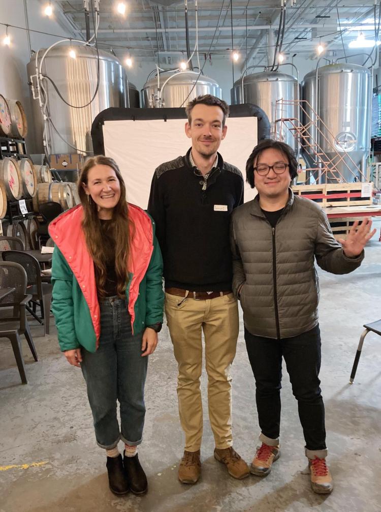 INSTAAR storytellers Emily Stuchiner (research scientist), Lennart van Maldegem (research staff), and Michael Dyonisius (postdoc). All participated in INSTAAR's first storytelling night, held at Sanitas Brewing Company in October 2023.