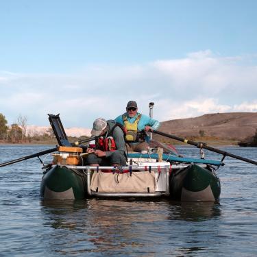 Mike Gooseff rows and Conor Newman takes samples while rafting the upper Colorado River to survey water quality.