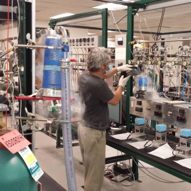 Researcher Chad Wolak prepares NOAA air samples for carbon-14 measurement. Photo by Scott Lehman. (image flipped for layout purposes)