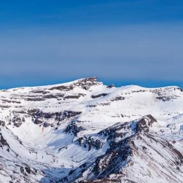 Snow covers the rugged terrain of Sierra Nevada mountaintops.
