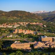 Aerial view of CU Boulder's east and main campuses with the foothills and continental divide