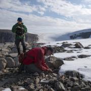 Simon Pendleton and Giff Miller collect ancient plant remains melted out of the edges of the ice cap on Baffin Island. Photo by Matt Kennedy, Earth Vision Trust.