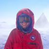 Annika Horlings, in puffy red parka and ski goggles, in blowing snow. Photo: John-Morgan Manos