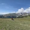 A lone ecologist kneels on a broad tundra field, high on Niwot Ridge Colorado