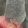 A close up of a fragment of an old ice core with bubbles inside