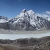 A glacial lake stretches below a rocky snow-capped peak in the Mount Everest region of Nepal. Photo by Alton Byers.