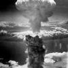 A black-and-white photo of the mushroom cloud rising above the nuclear bomb blast in Nagasaki during World War II
