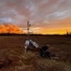 Smoke from a wildfire is visible behind a permafrost monitoring tower at the Scotty Creek Research Station in Canada's Northwest Territories in September. The tower burned down in October from unusual wildfire activity. Photo by Joëlle Voglimacci-Stephanopoli.