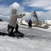 Miles Moore and Jimmy Howe toss black sand onto a test plot on Niwot Ridge. Photo by Kelsey Simpkins, CU Boulder.