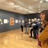 An artist discusses Colorado's environmental issues with community members at a CASE exhibition.